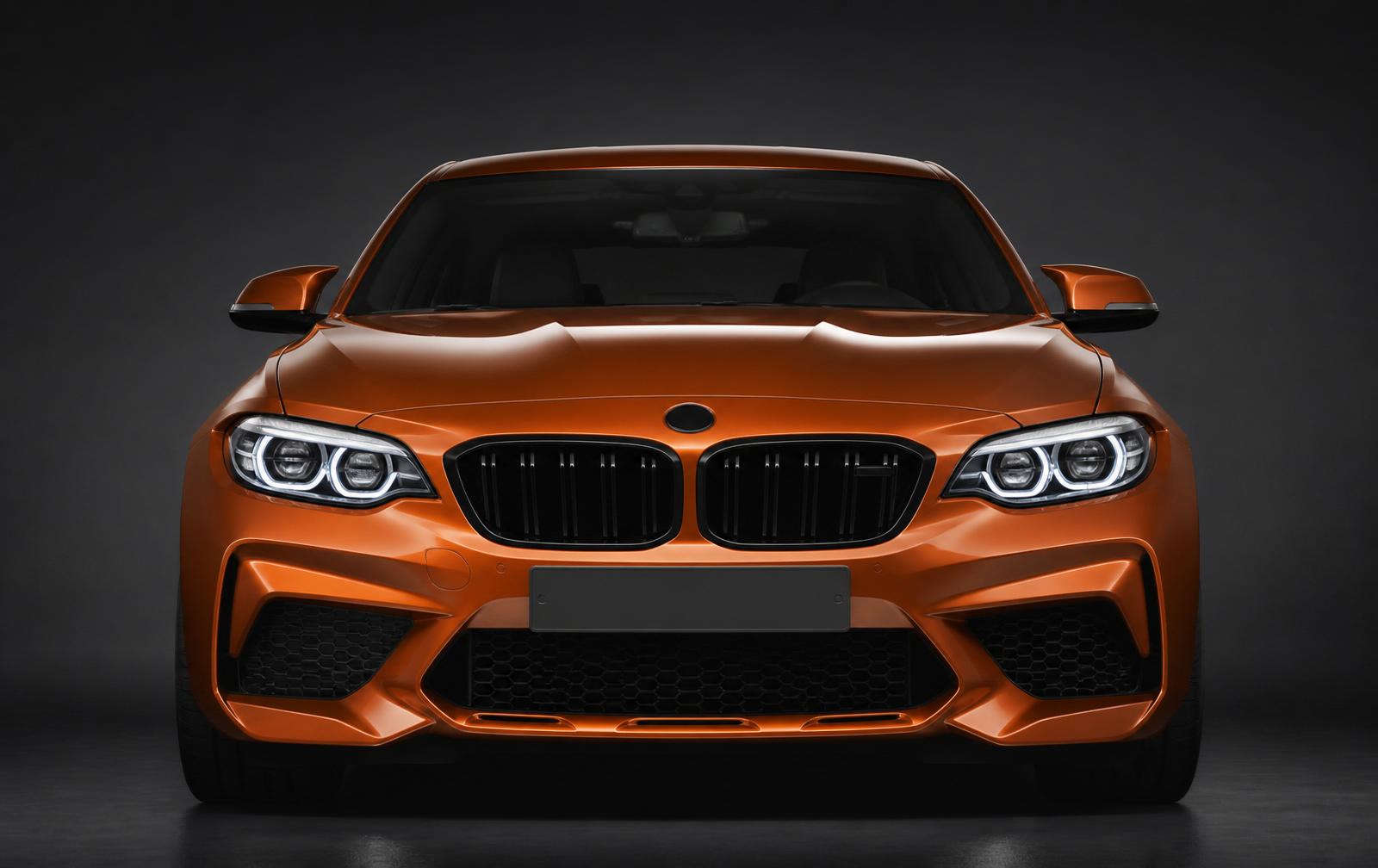 Centered front view of a premium orange sports car with SmartPlate mounted in the license plate recess